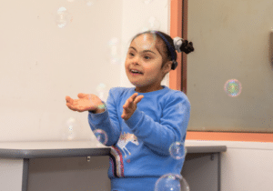 Hawa Abdallah playing with bubbles at Kurrajong Therapy Plus.