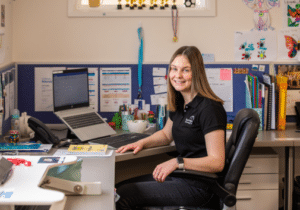 Physiotherapist Katie Rudgley sitting at her desk facing the camera.