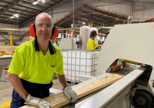 Kurrajong Timer employee Jason Burt standing at a timber saw.